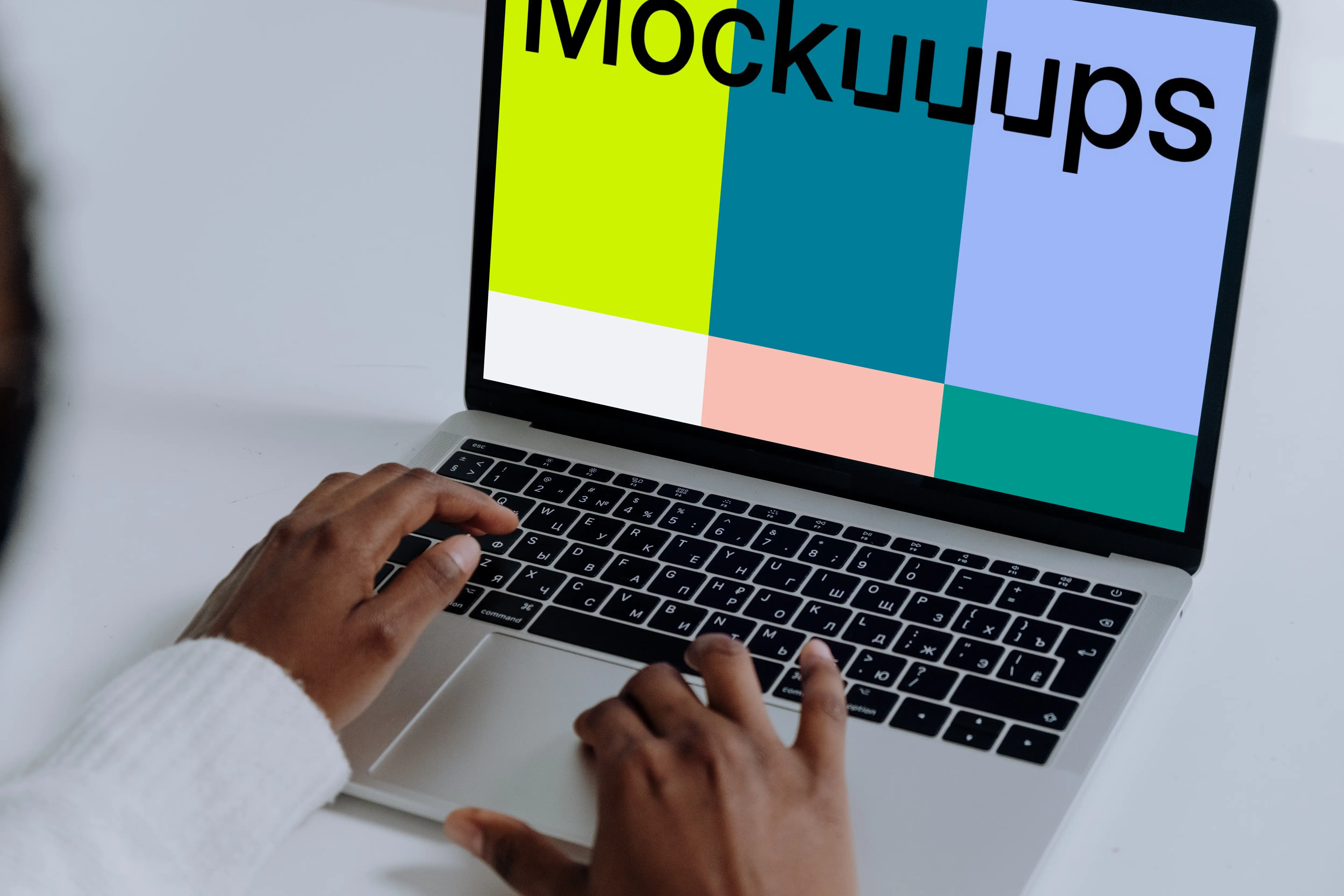 MacBook Pro mockup on a white table used by woman