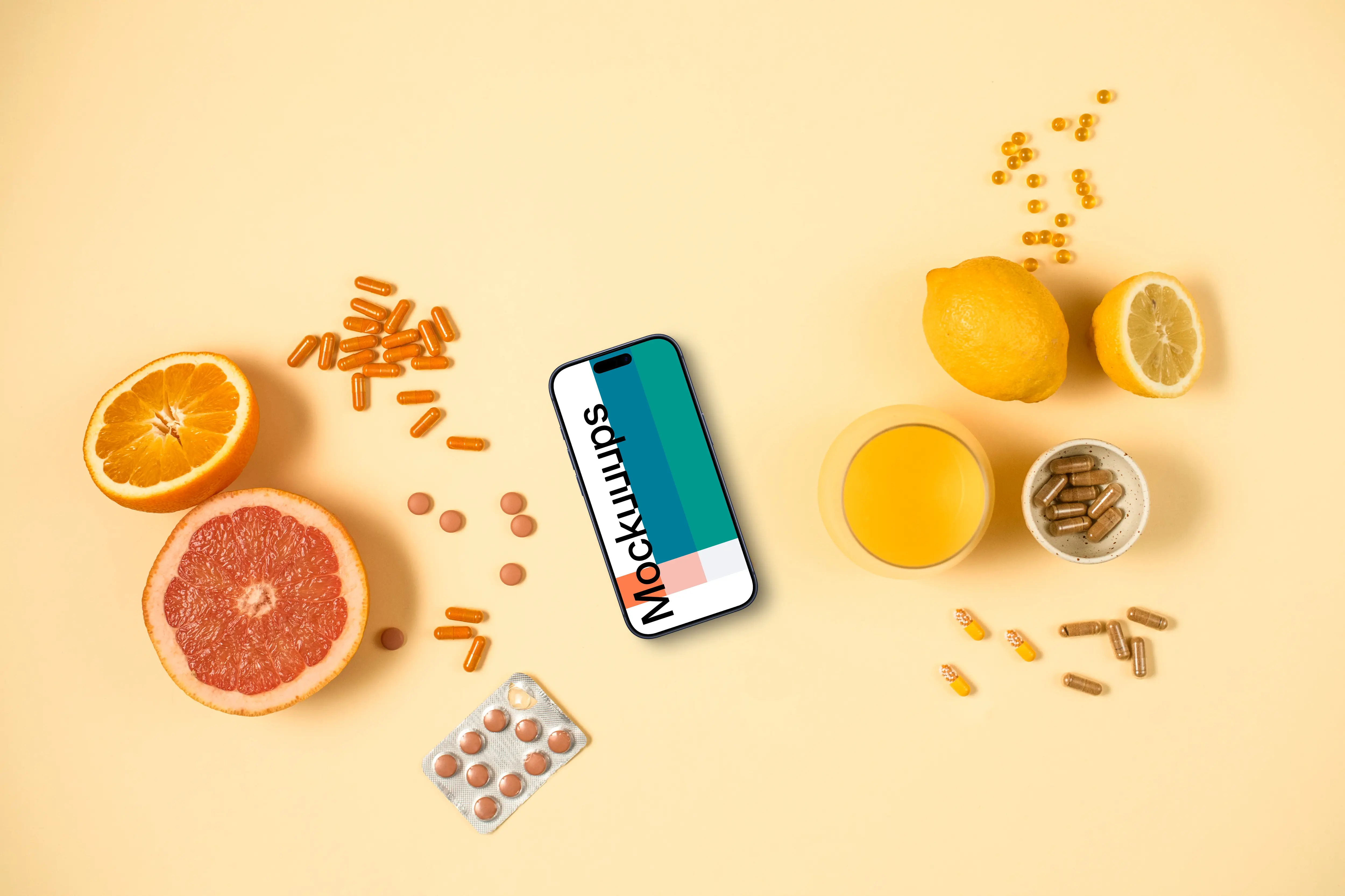 Phone surrounded by pills and citrus fruits