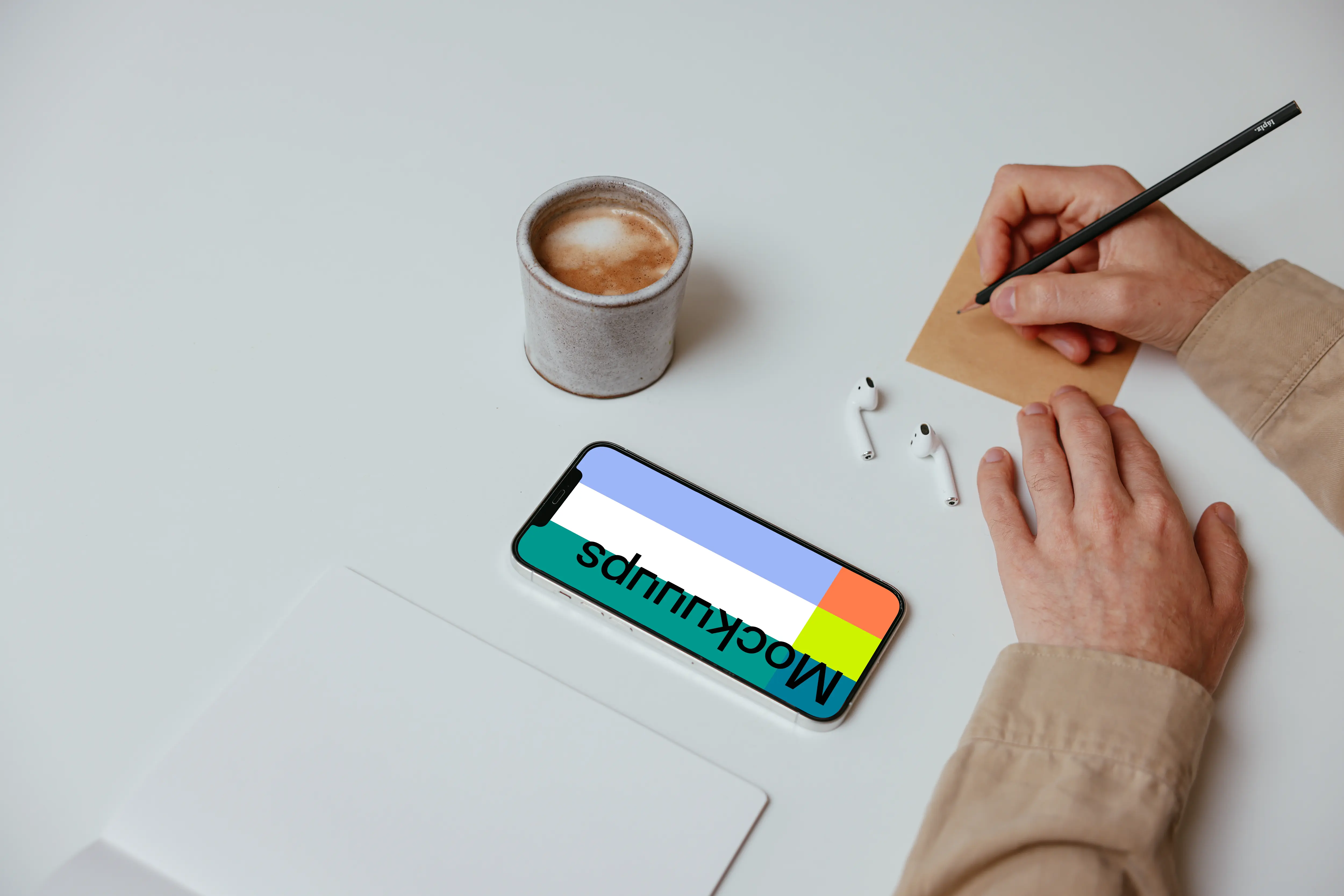 Simple iPhone mockup on a table beside a pair of Airpods