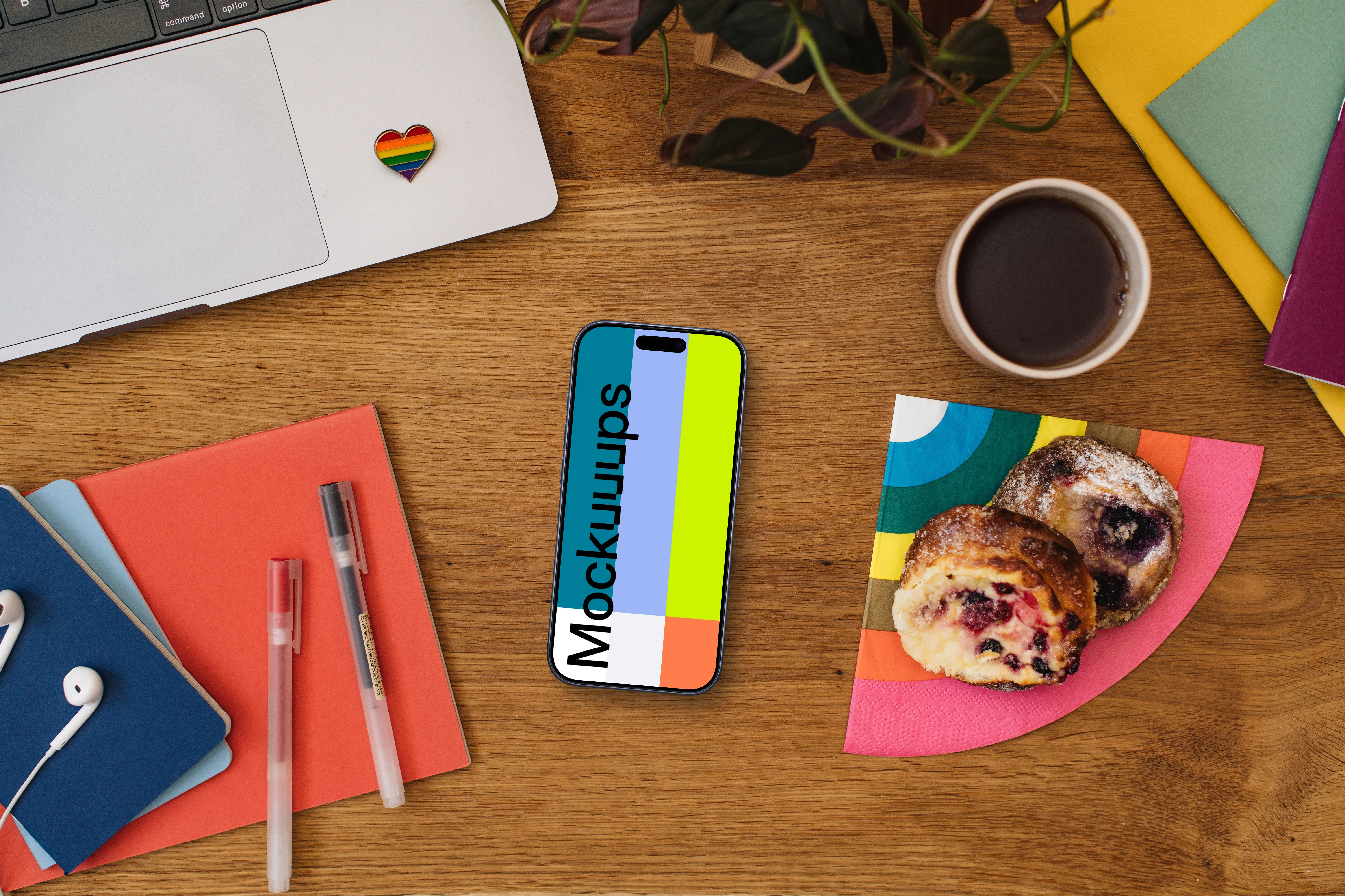 Work desk with a smartphone mockup and pride decorations
