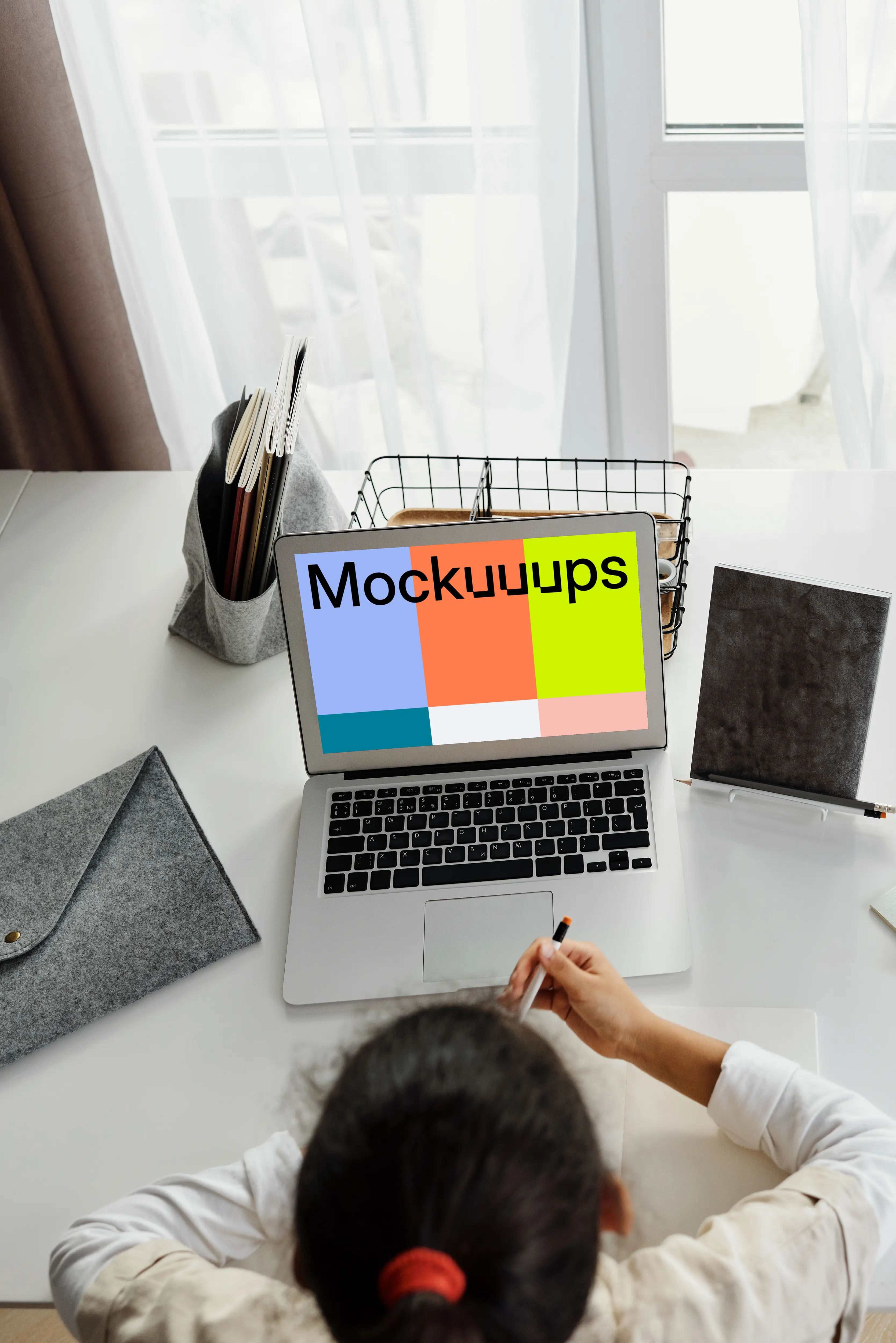 Young girl using a MacBook Air with a bag by the side mockup
