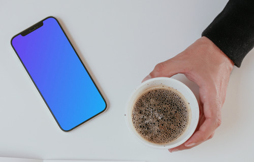 Minimal iPhone mockup on a table with a cup of coffee by the side