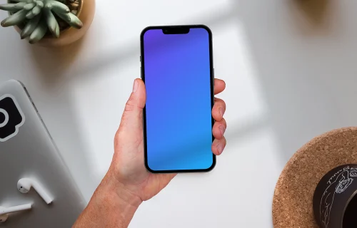 Holding phone mockup on top of the table