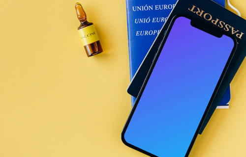 iPhone 12 Pro mockup on a passport beside a vial of vaccine
