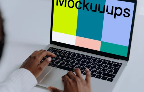 MacBook Pro mockup on a white table used by woman