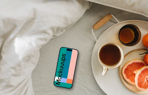 Sun-kissed breakfast scene including an iPhone mockup