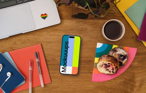 Work desk with a smartphone mockup and pride decorations