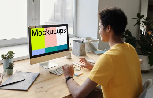 Young boy smiling at an iMac mockup