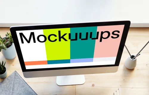 Young girl holding a pencil and using her iMac mockup