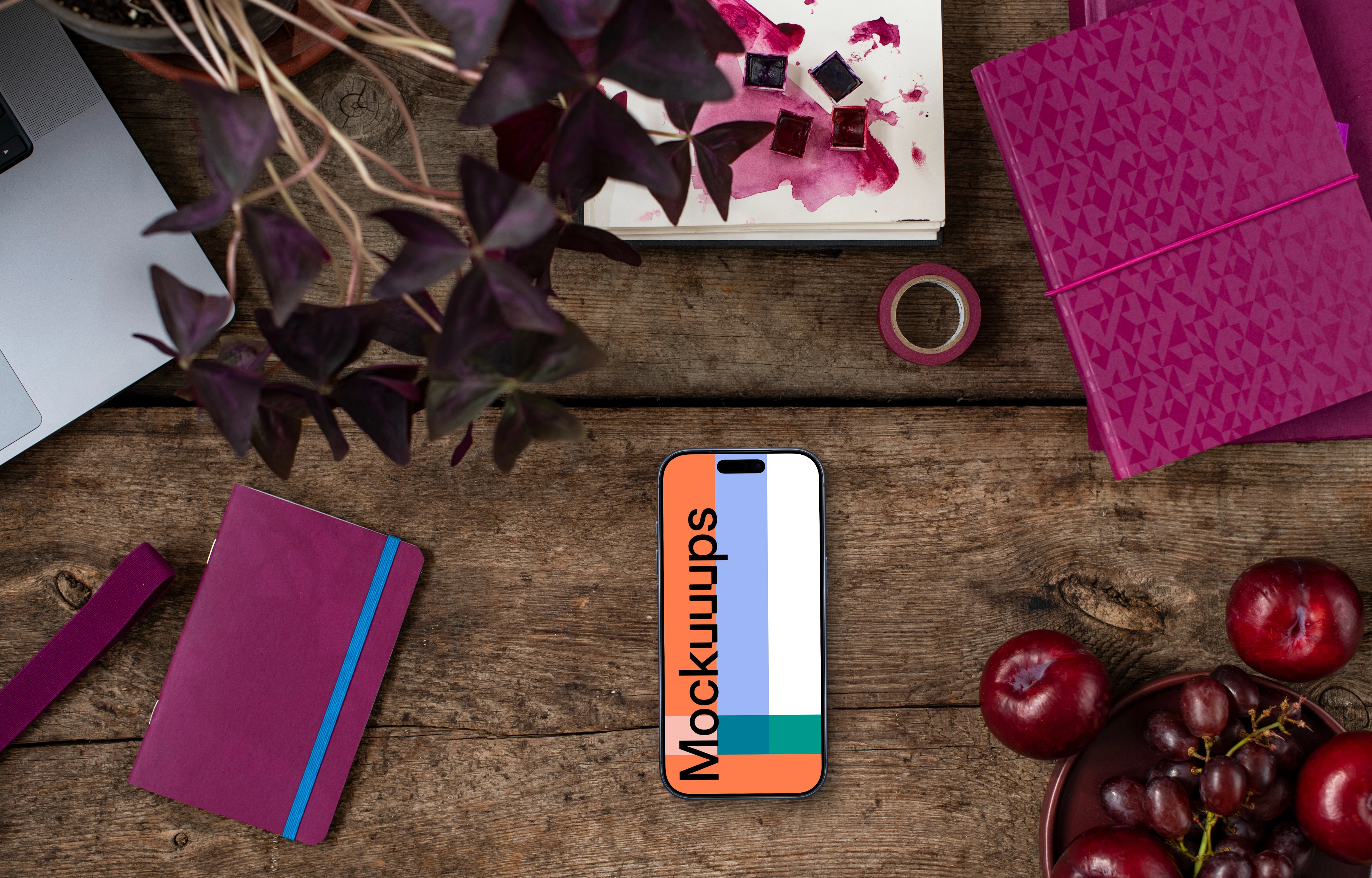 Books in Viva Magenta shades next to the phone