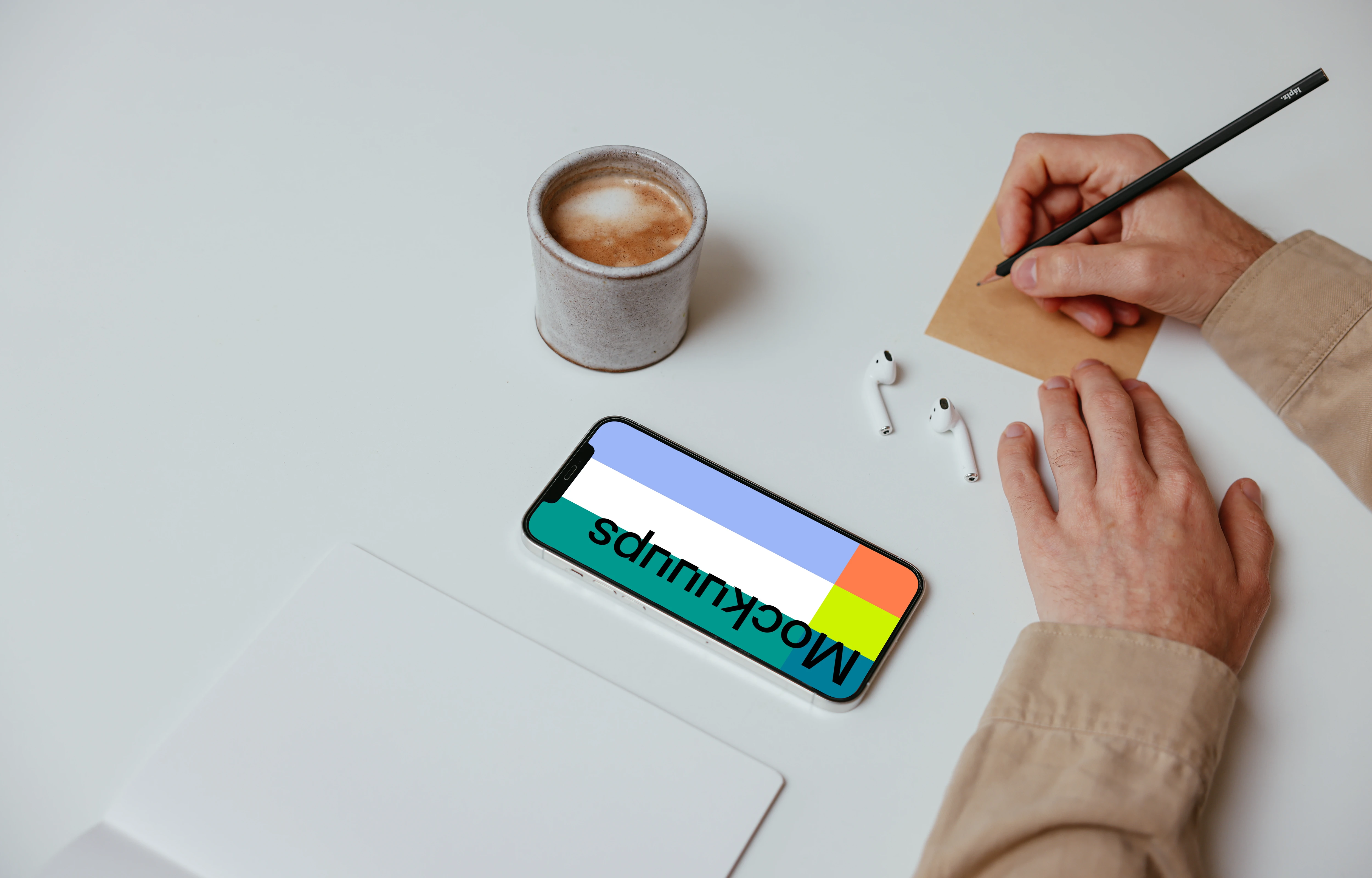 Simple iPhone mockup on a table beside a pair of Airpods