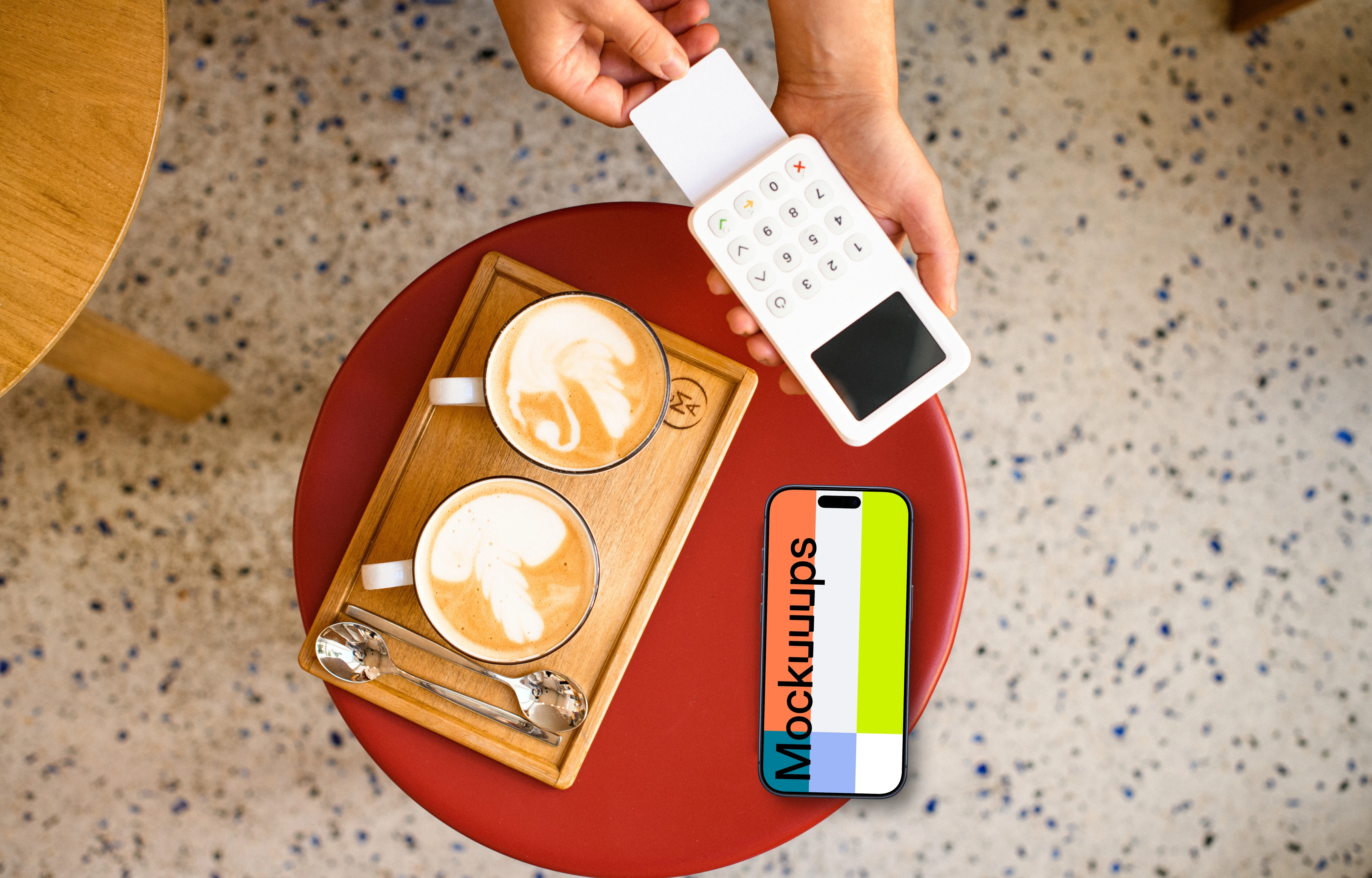 Cozy cafe setting with payment terminal and an iPhone mockup