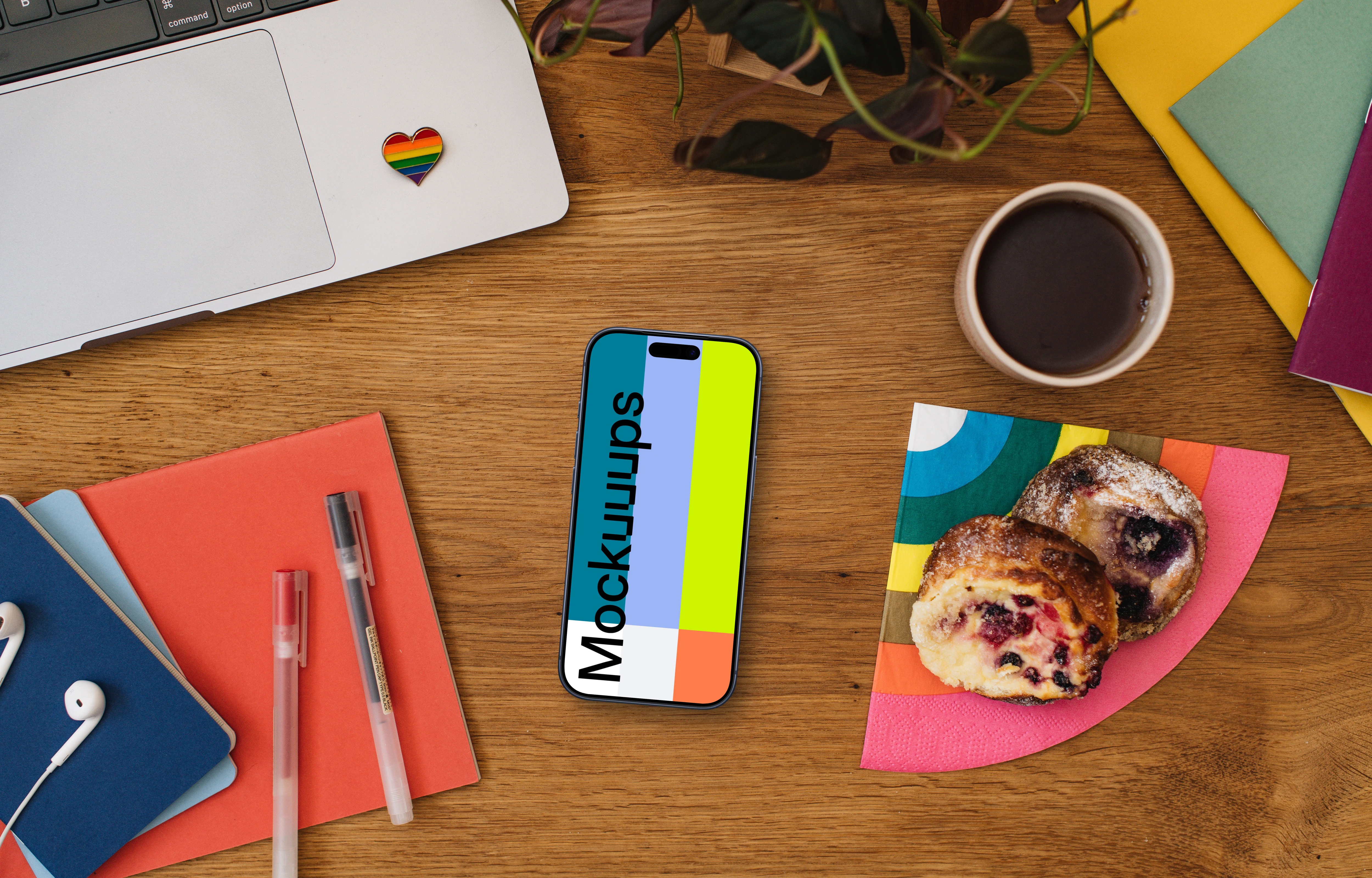 Work desk with a smartphone mockup and pride decorations
