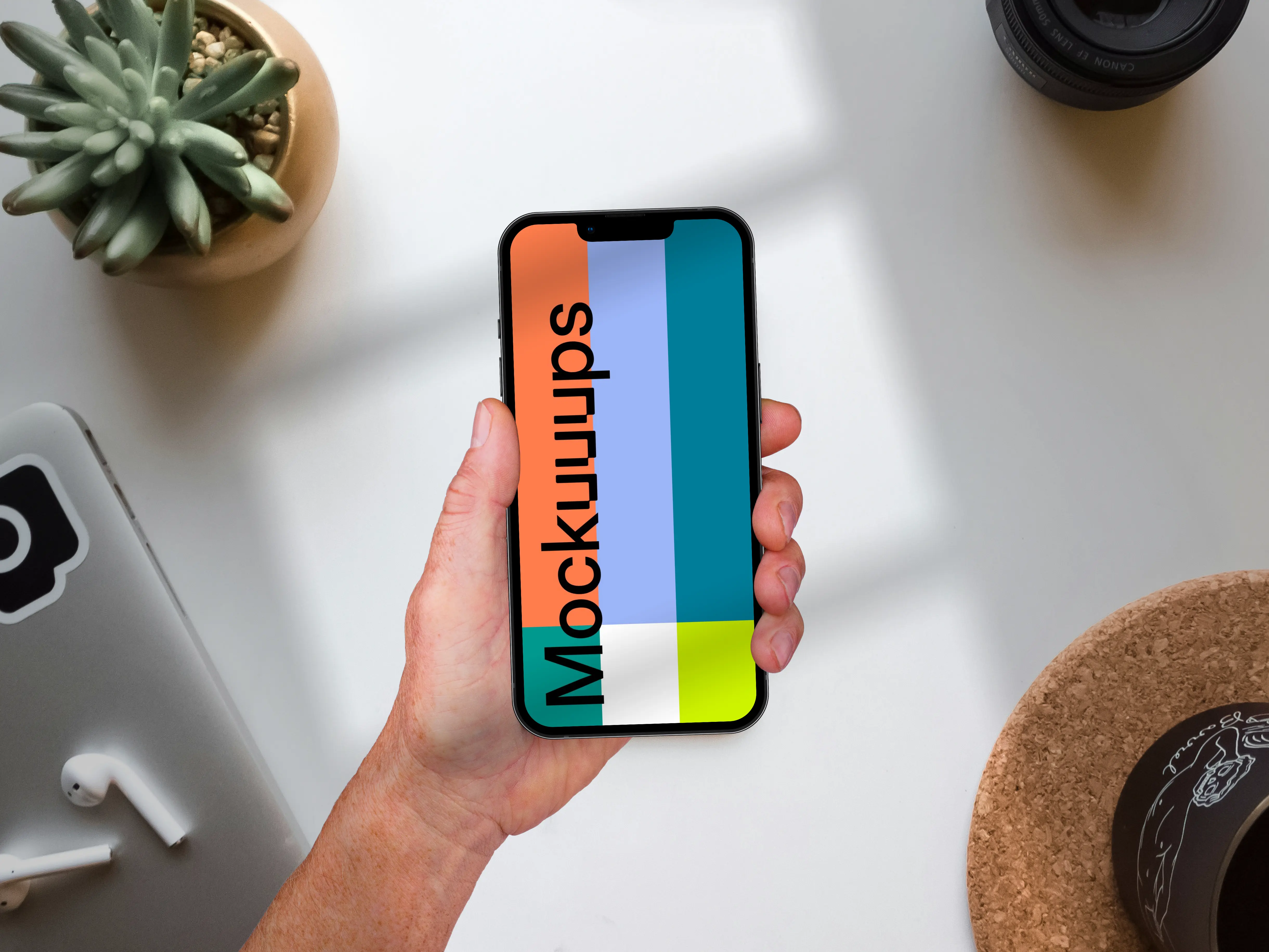 Holding phone mockup on top of the table