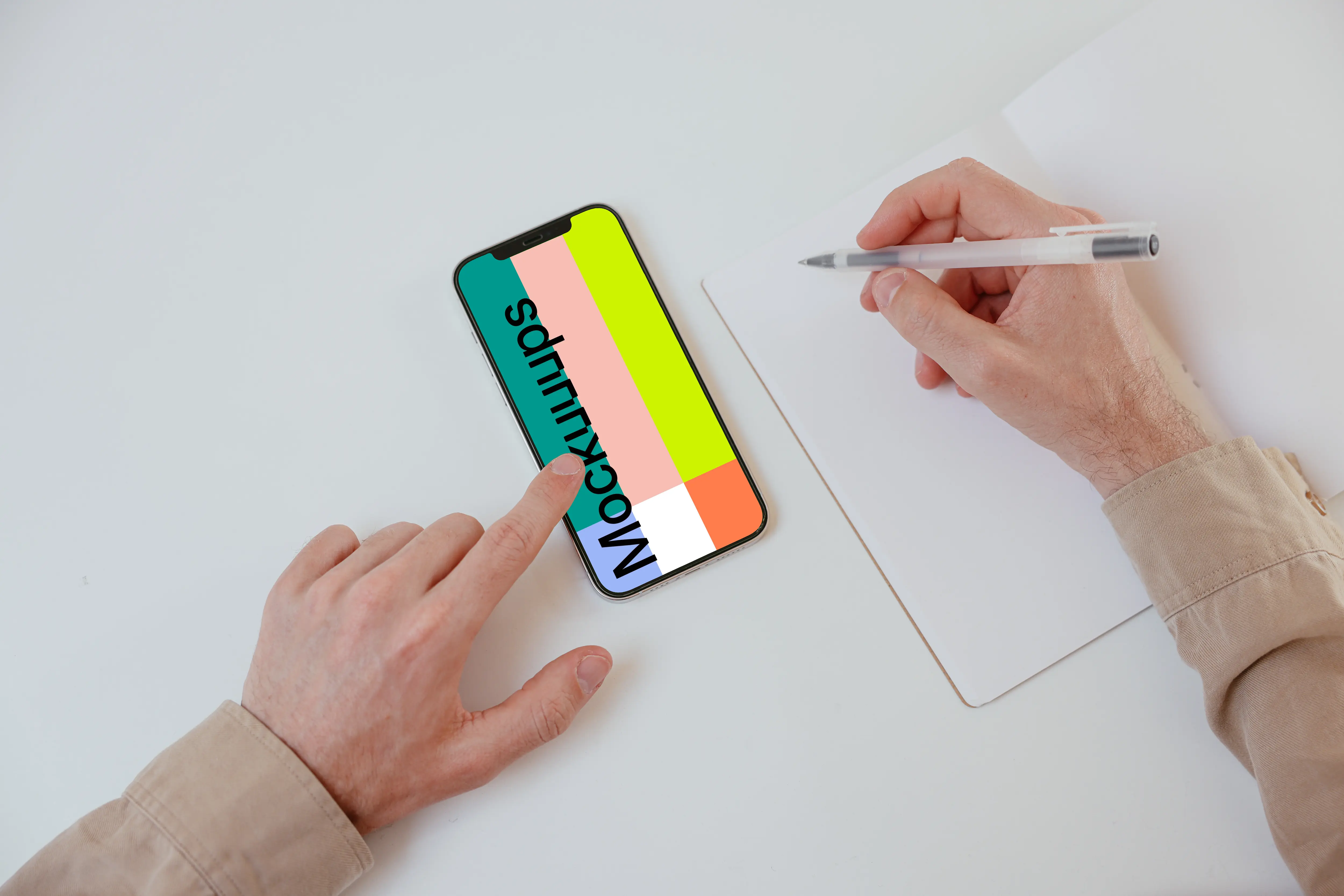 iPhone mockup on a white table with a textbook at the side