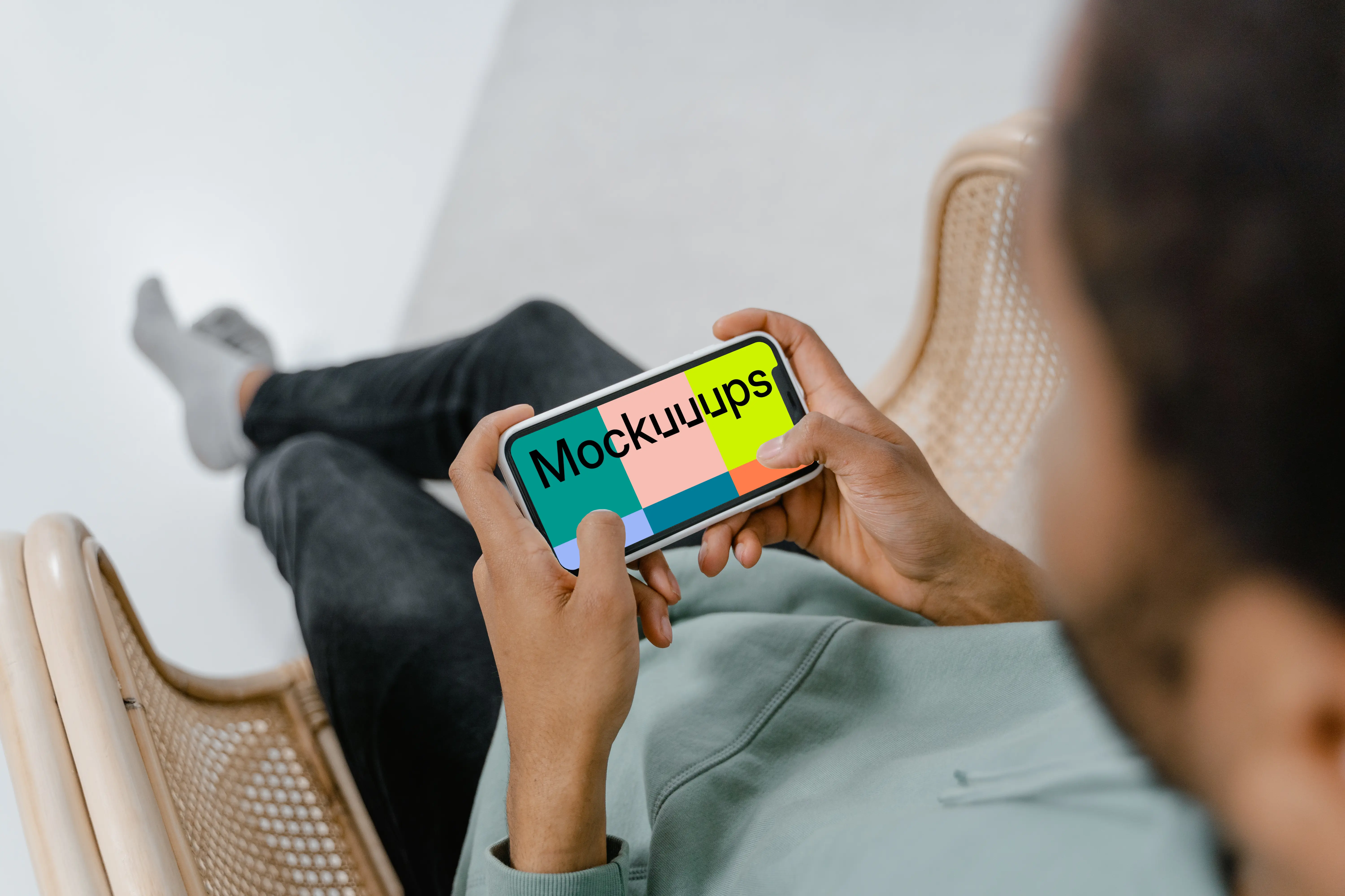 User holding iPhone in landscape mode mockup 