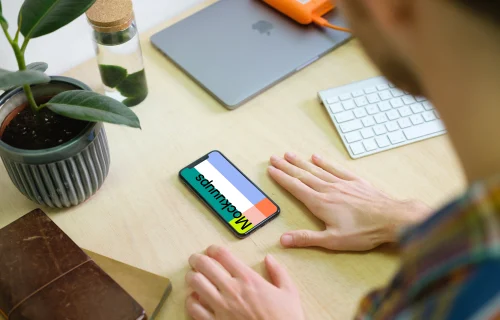Man with iPhone 11 mockup in the office