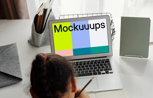 Young girl with ponytail studying with her MacBook Air mockup