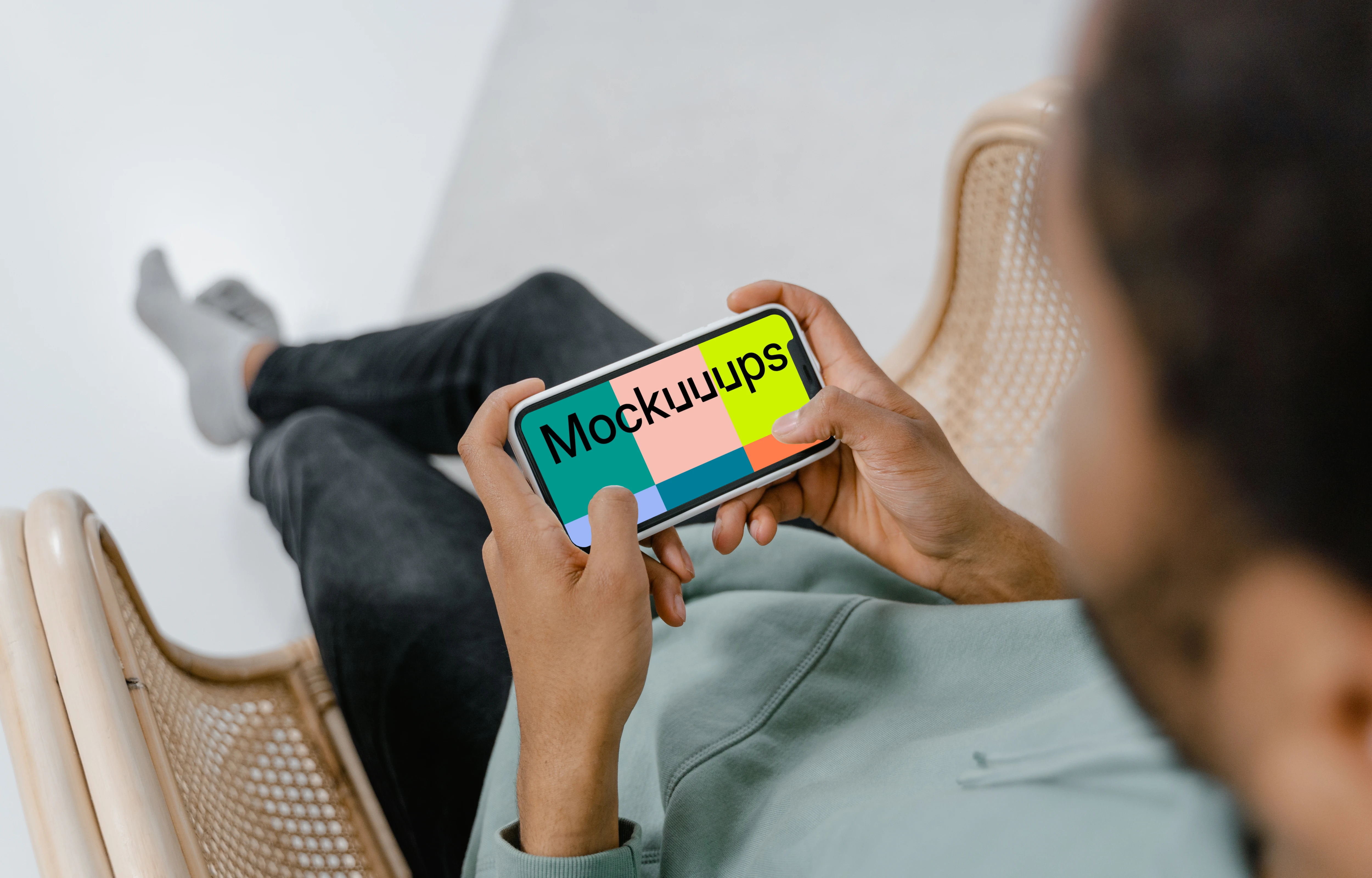 User holding iPhone in landscape mode mockup 