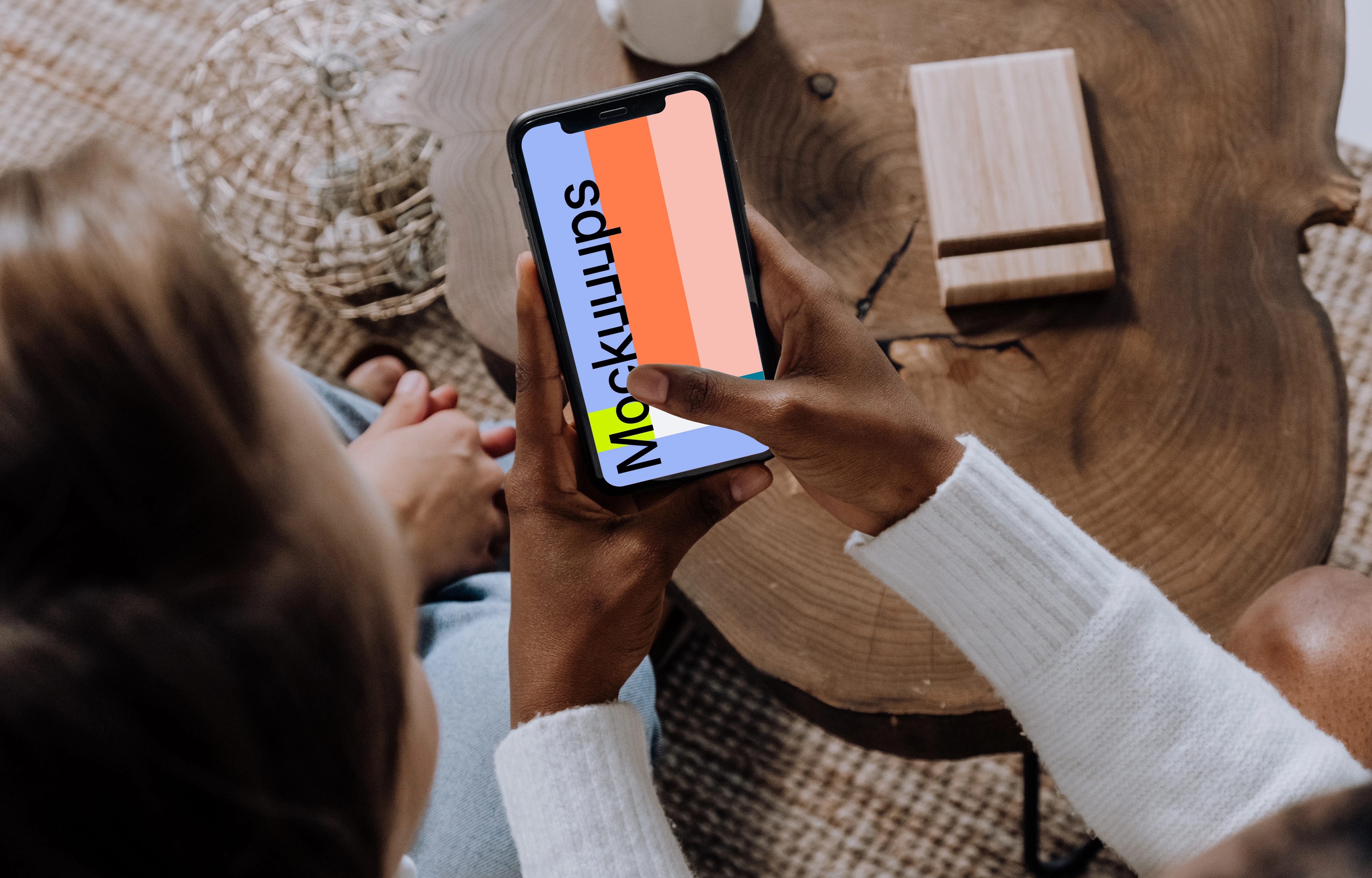 iPhone mockup in a ladies hand beside a friend.