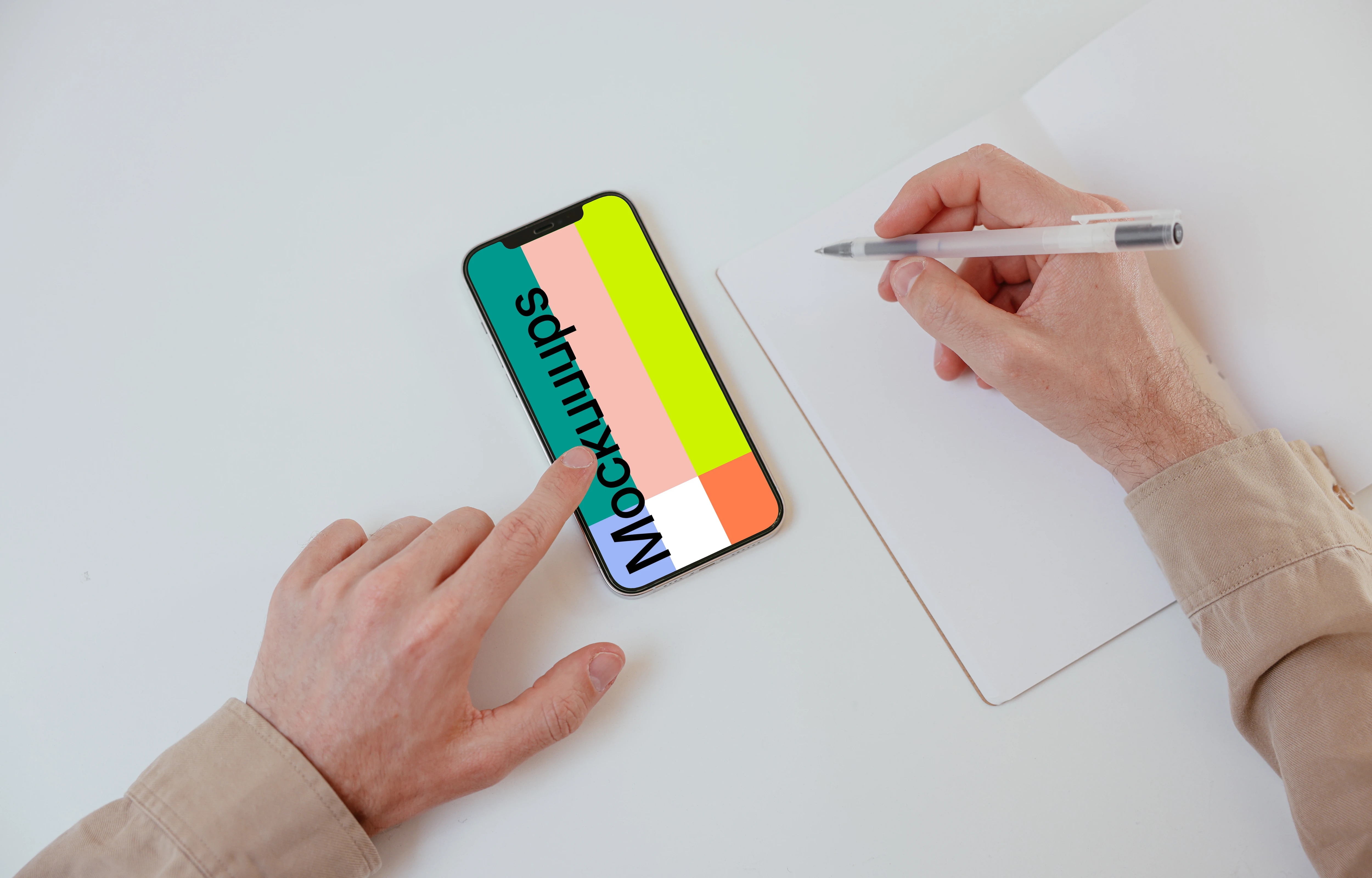 iPhone mockup on a white table with a textbook at the side