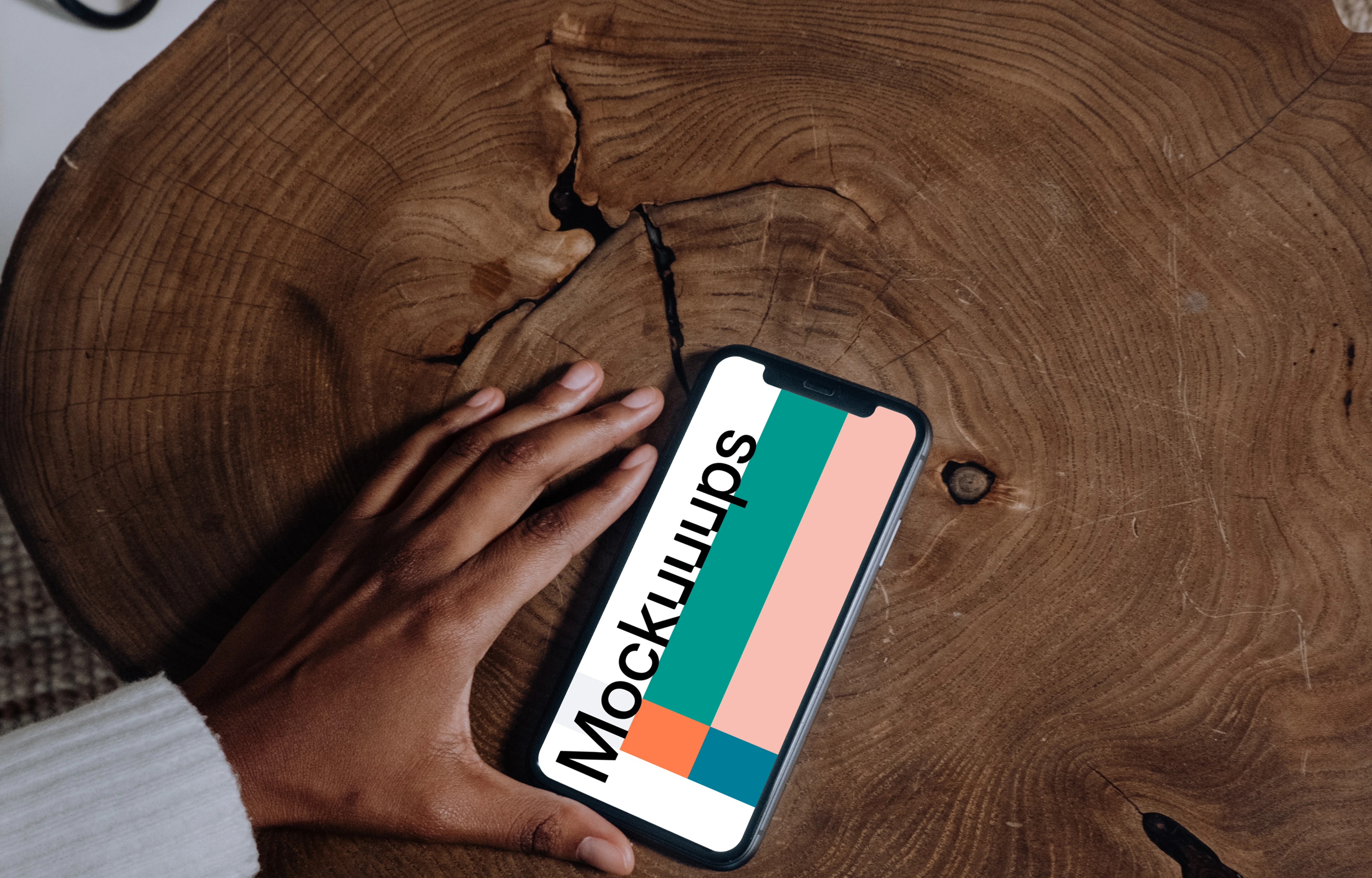 iPhone mockup on brown wooden center table