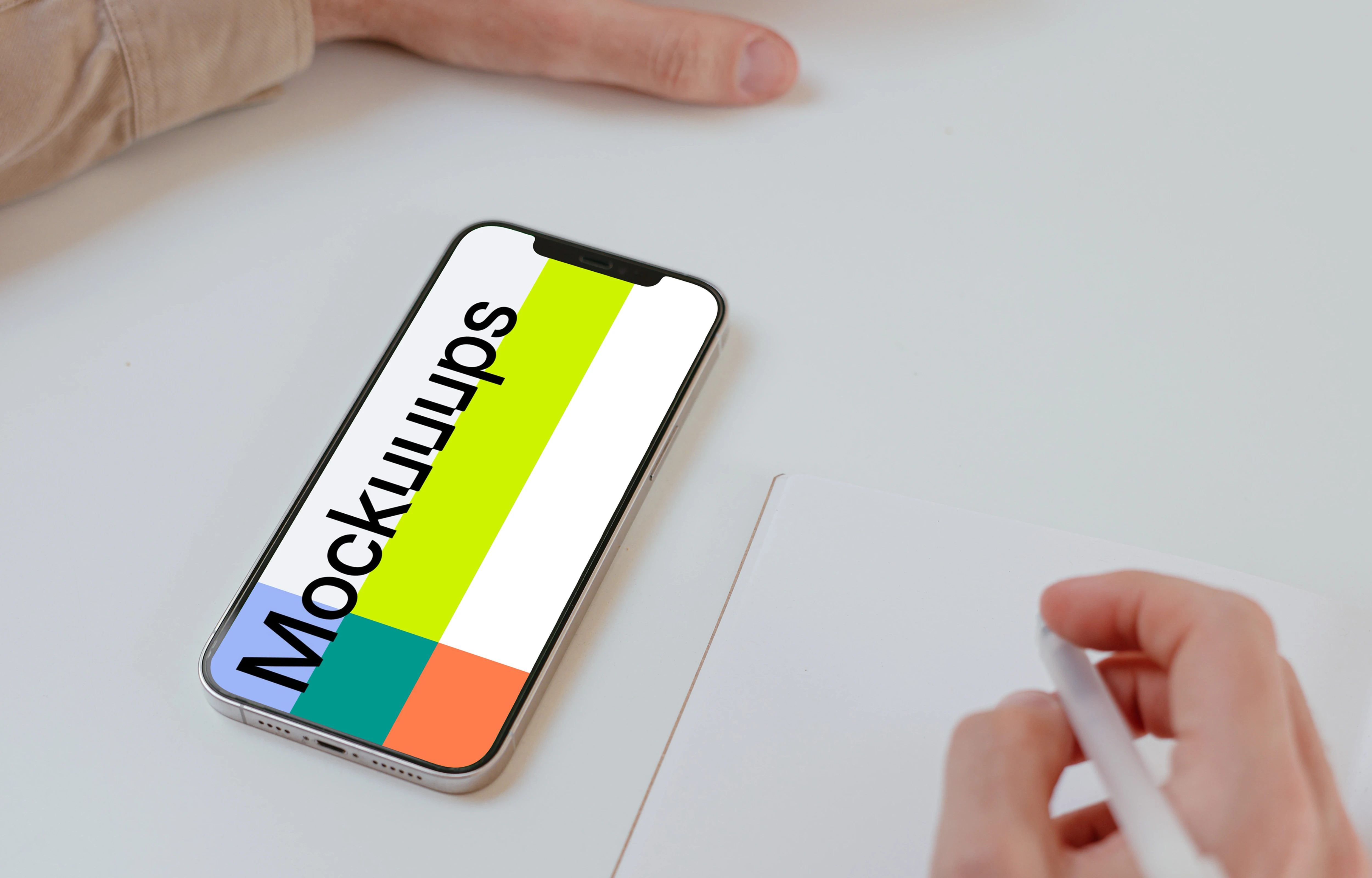 Simple iPhone mockup on a white table beside a book