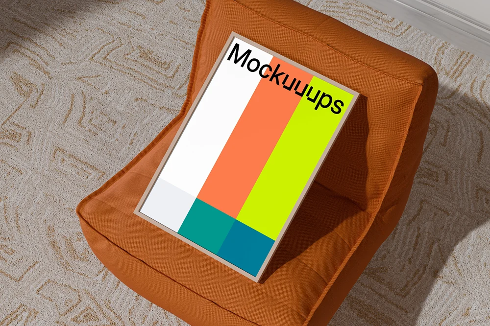A3 poster mockup on an orange pouf mockup