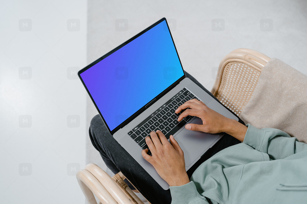 Grey MacBook mockup on user’s laps