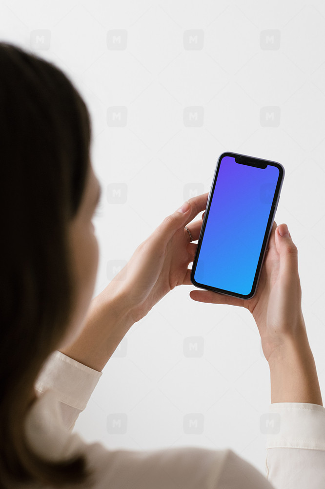 iPhone mockup held up by a woman