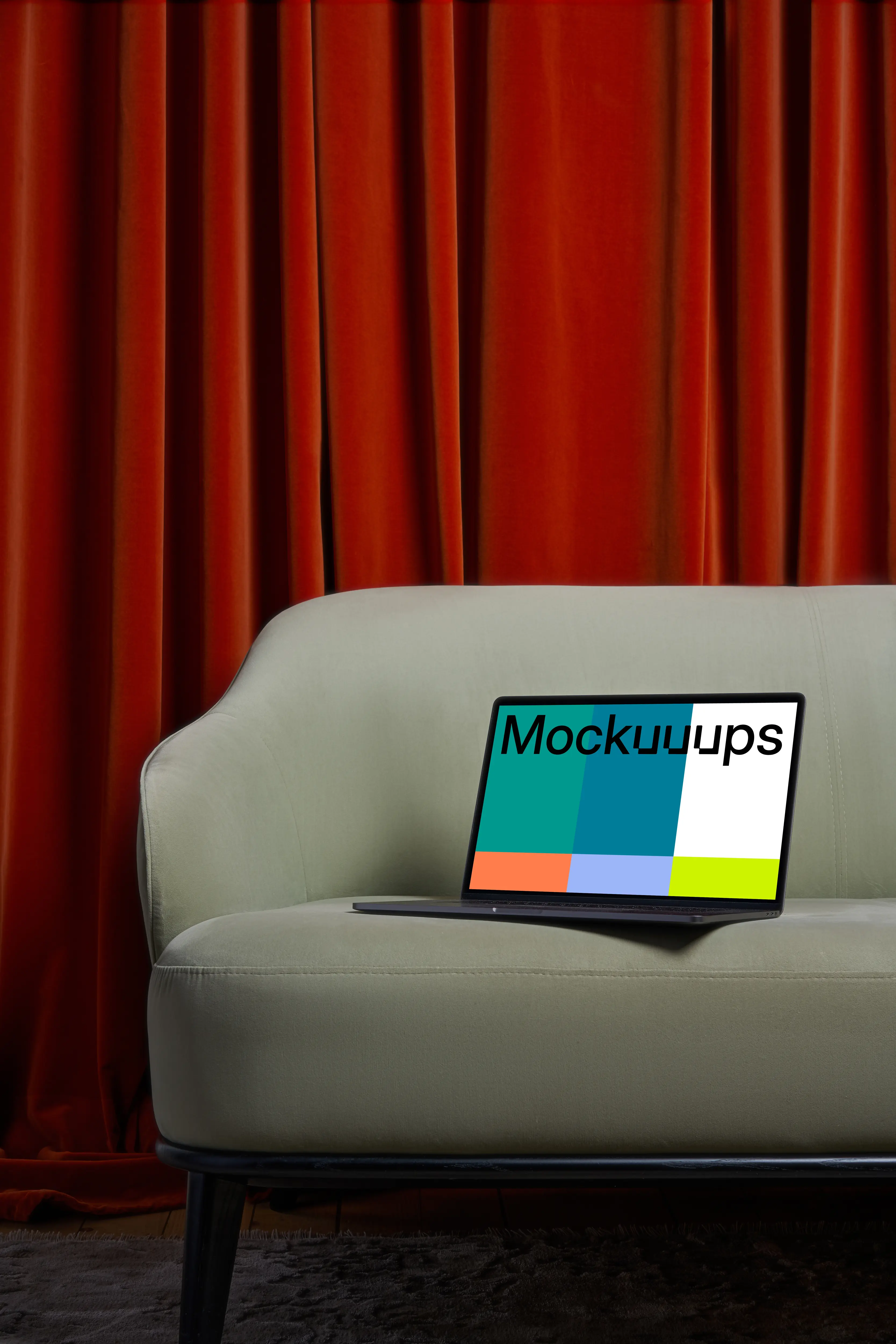 MacBook mockup on a couch with a red curtain in the background mockup