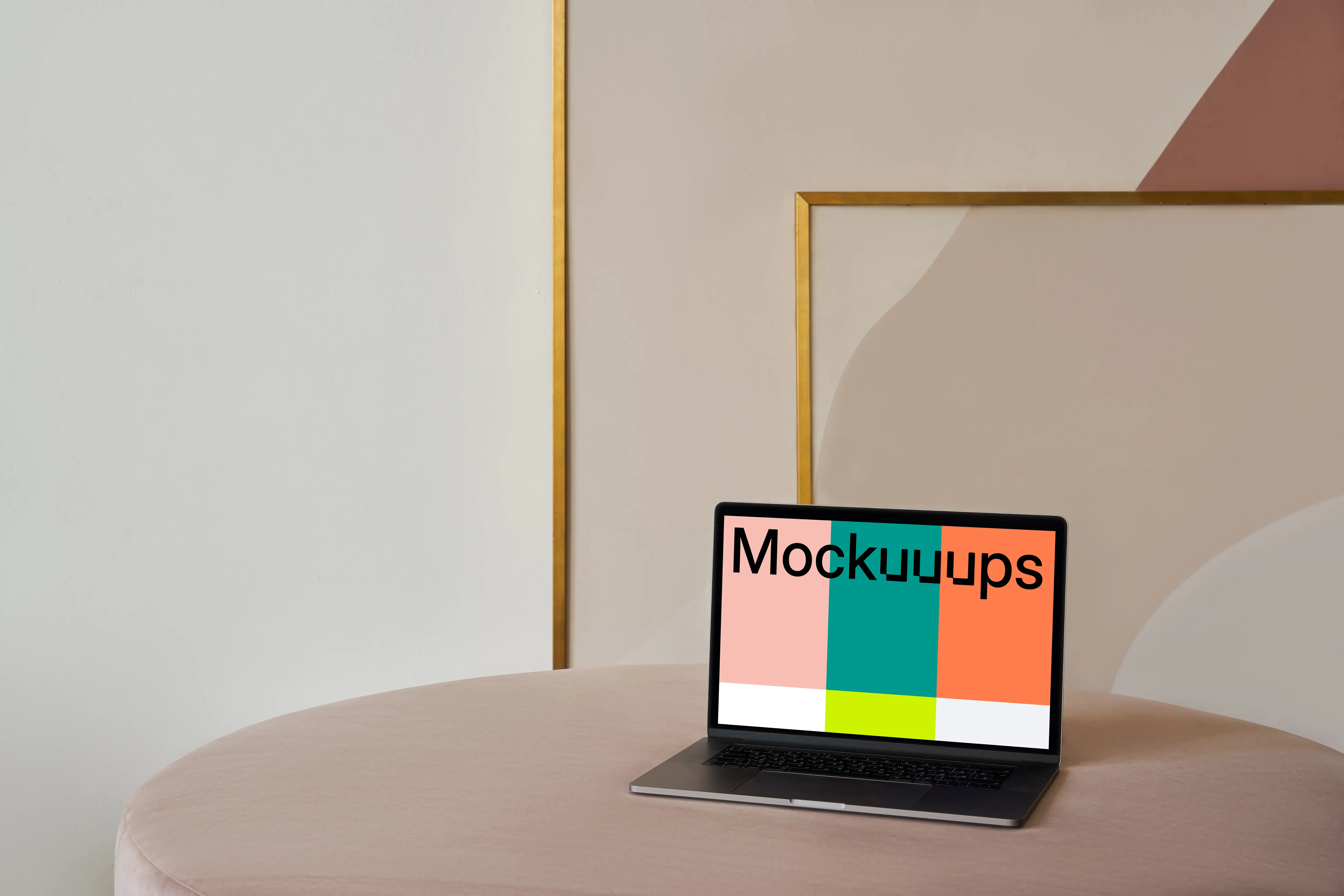 MacBook mockup on a table with a beautiful painting behind it