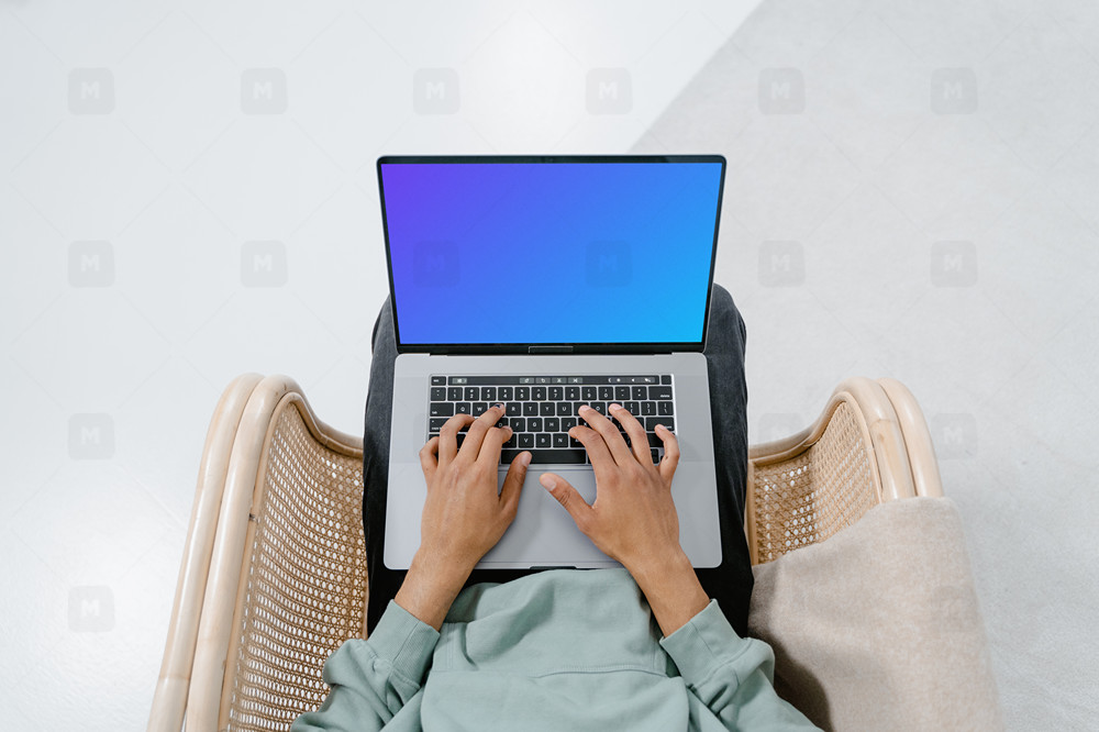 MacBook mockup on a user's laps