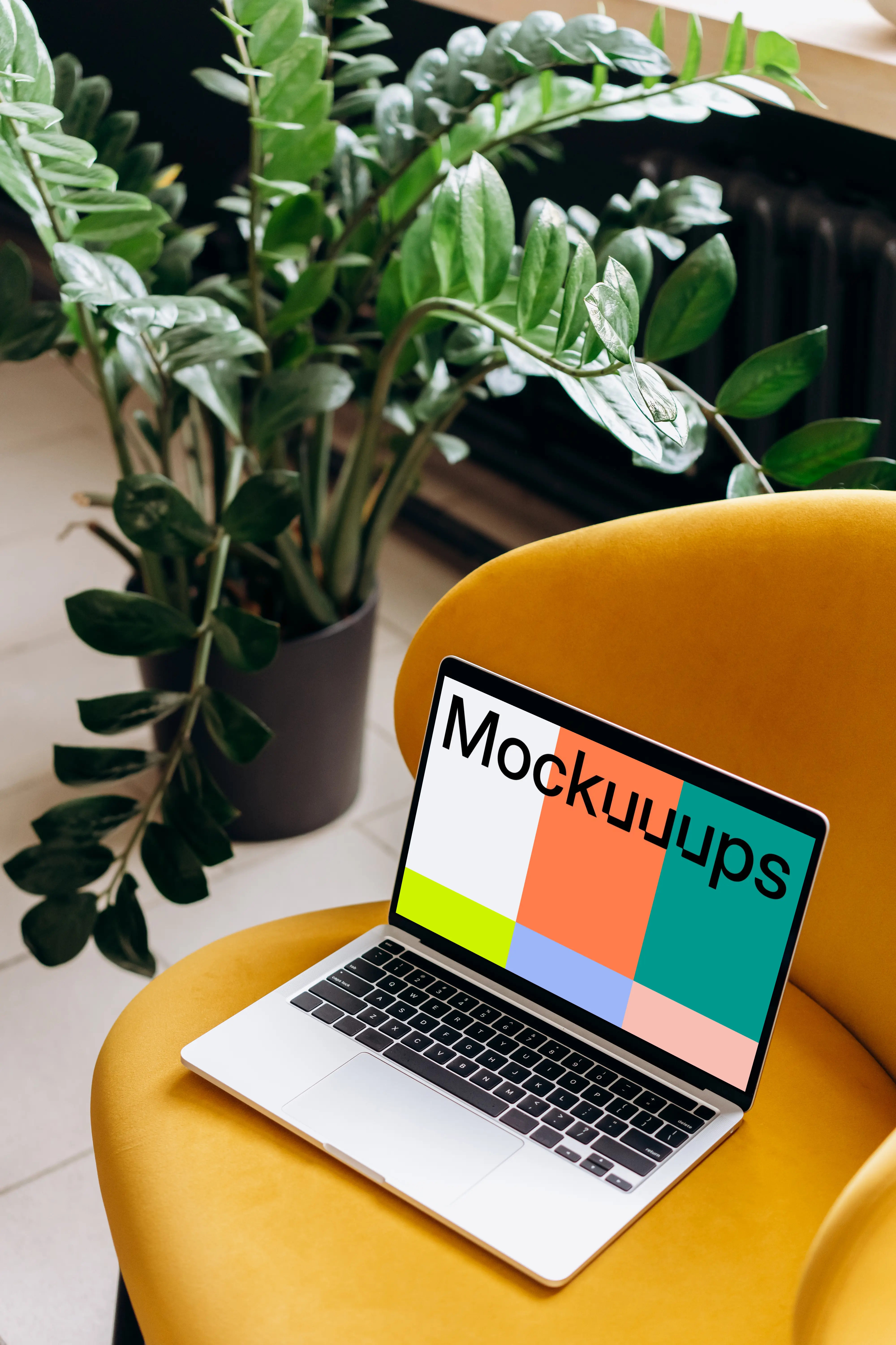 MacBook Pro mockup placed on a yellow chair mockup