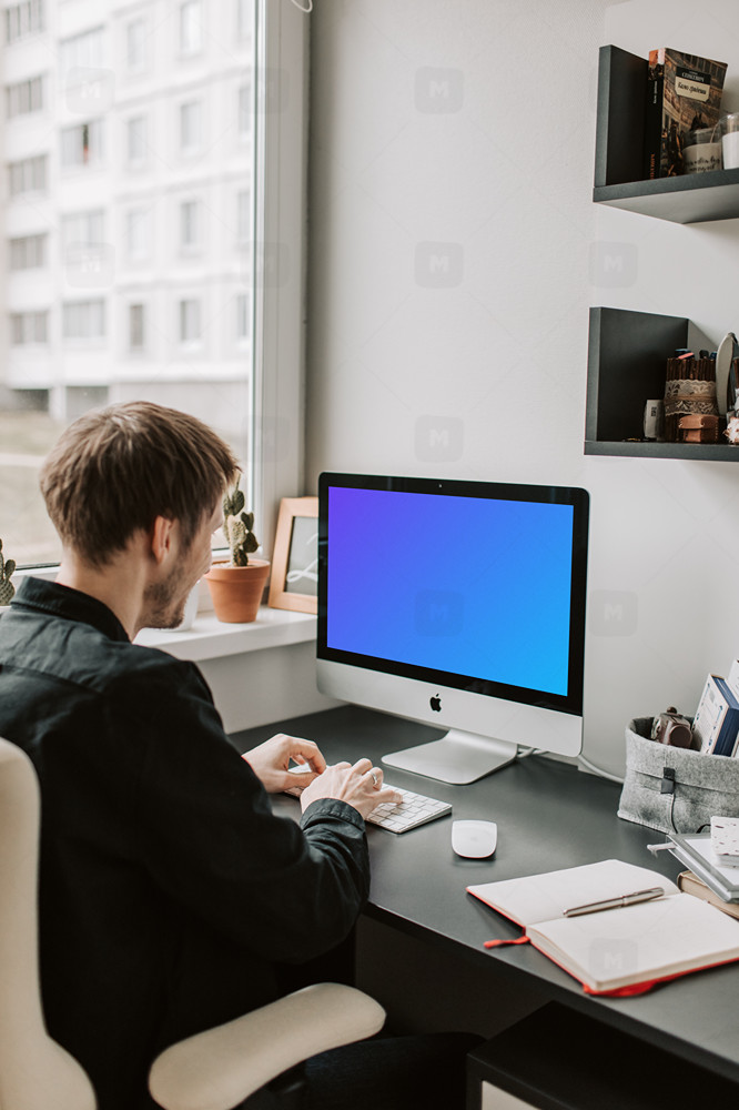 Man typing into his iMac mockup