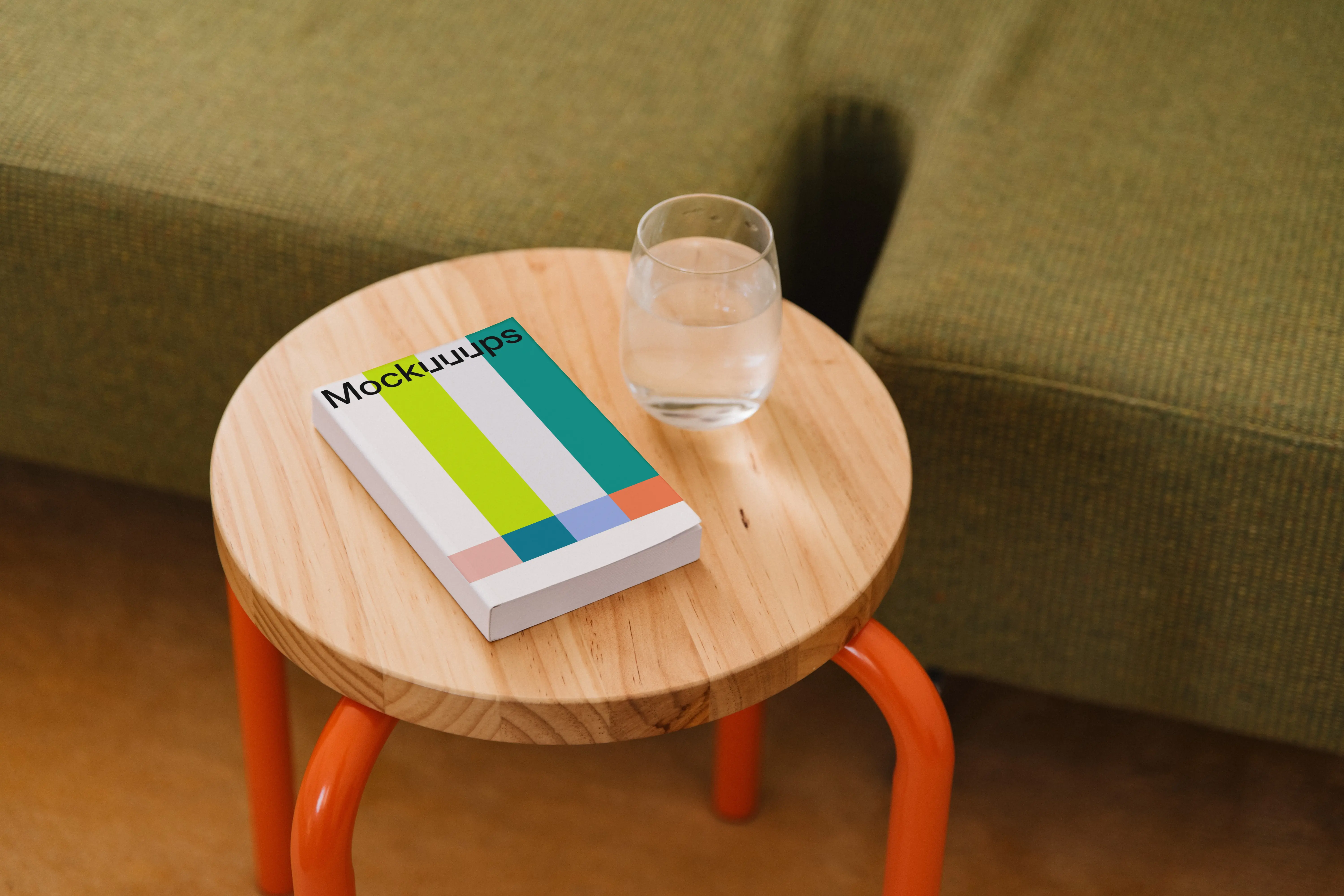 Mockup of a softcover book on a wooden side table mockup