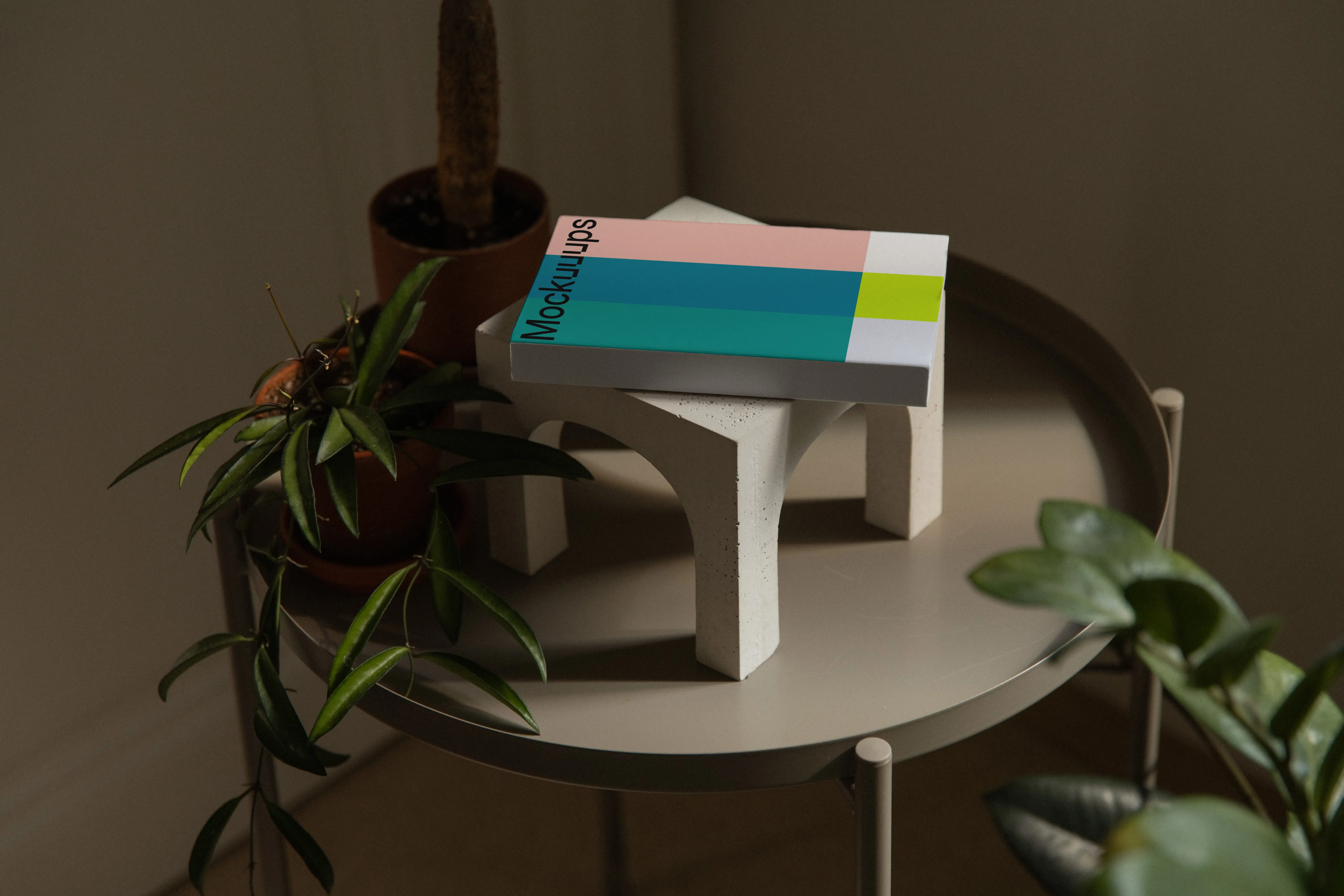 Softcover book mockup on a decorative table mockup