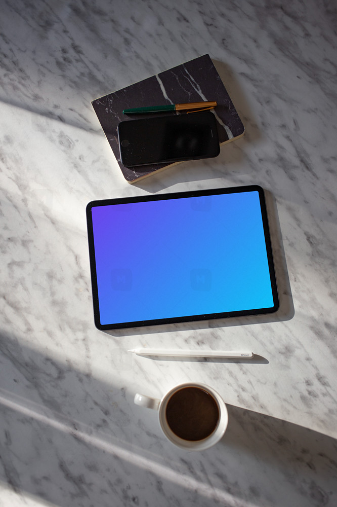 Tablet mockup on a table with an iPhone at the side