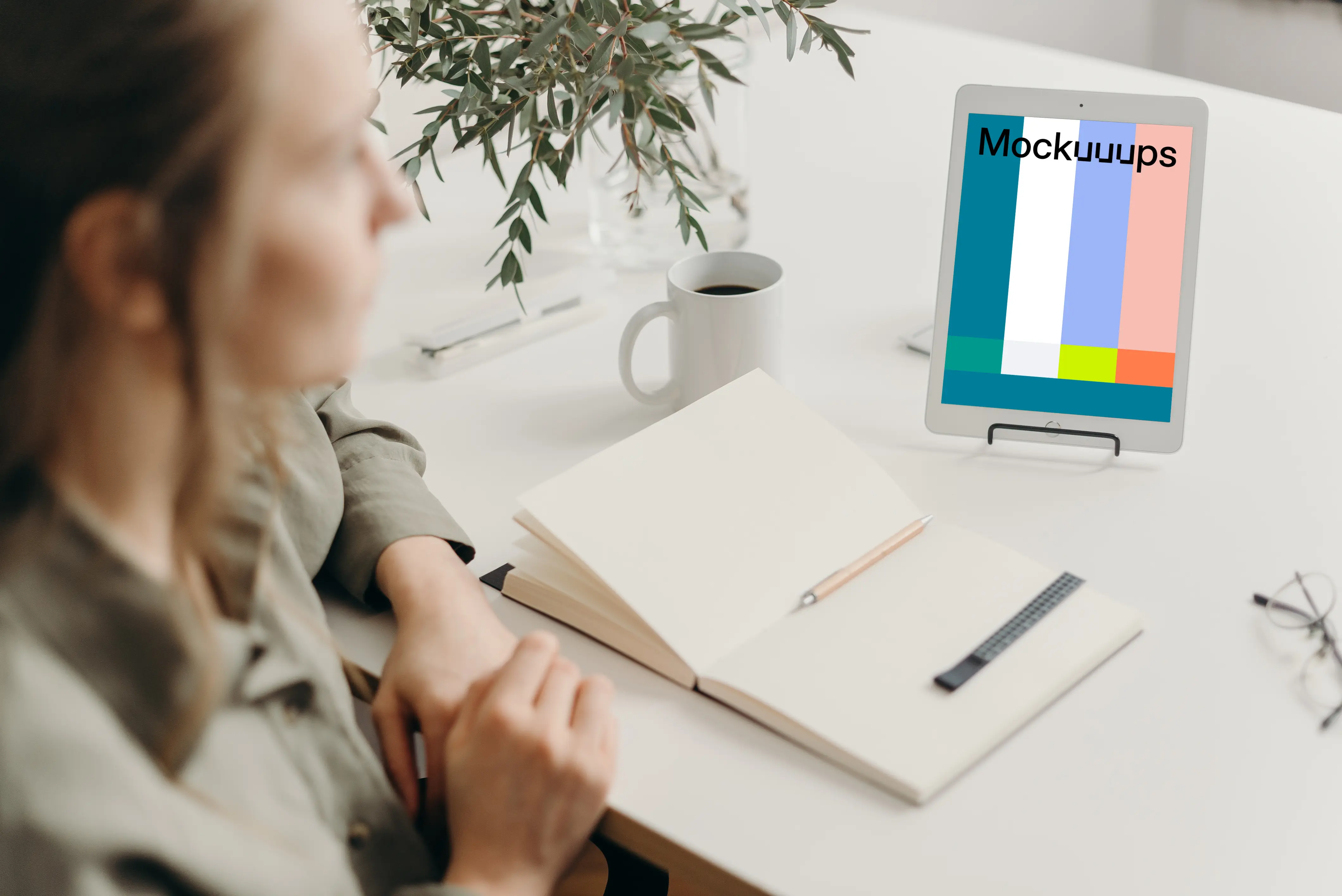 Tablet mockup on a white table with a diary at the side
