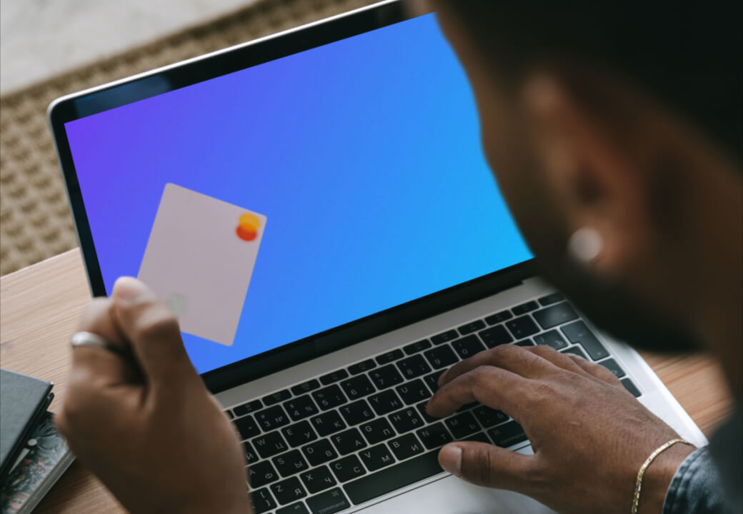 Mockup of man entering his card details into his MacBook