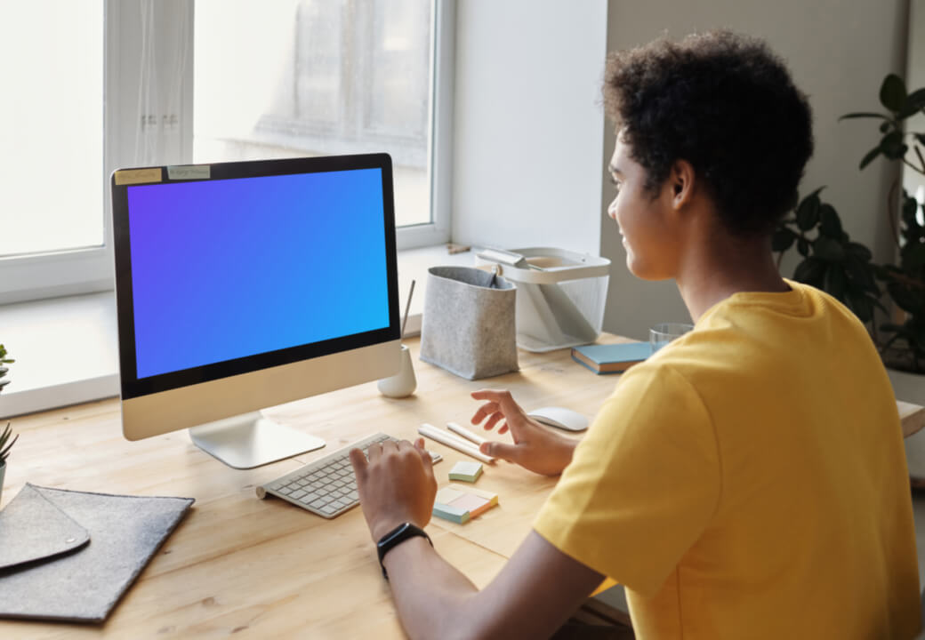 Young boy smiling at an iMac mockup