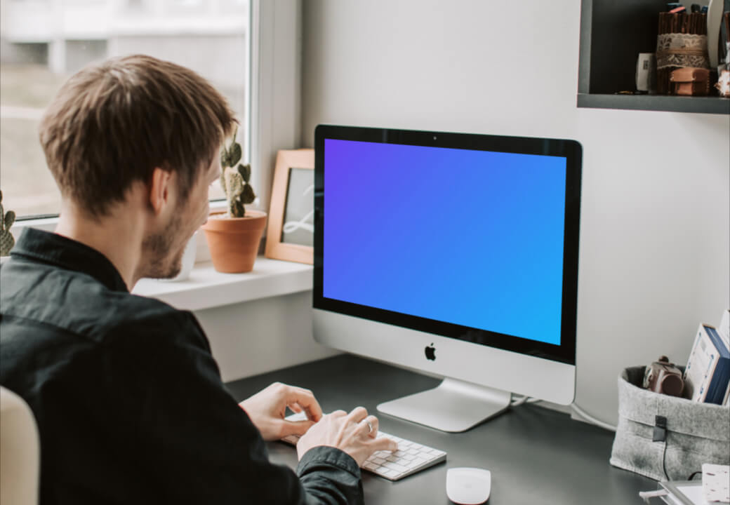Man typing into his iMac mockup